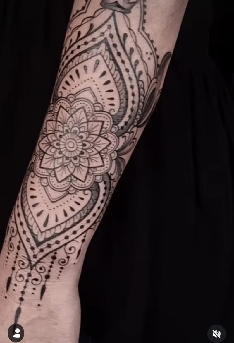 Mandala ornamental forearm tattoo