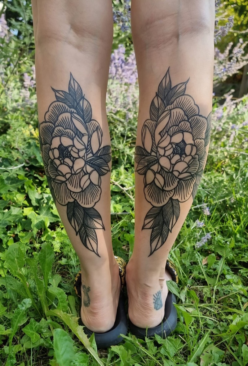 Botanical peony tattoos on calves